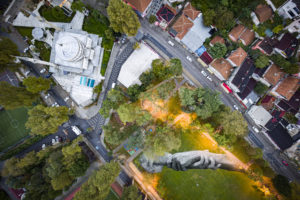 An aerial view shows a giant landart fresco by French-Swiss artist Saype, painted for the 8th step of his worldwide "Beyond Walls" project  in the Beykoz district, Istanbul, Turkey, on Sunday October 18, 2020. Three frescoes were created using biodegradable pigments made out of charcoal, chalk, water and milk proteins. The "Beyond Walls" aims at creating the largest symbolic human chain around the world promoting values such as togetherness, kindness and openness to the world. Here in Istanbul this step links Europe to Asia : one artwork was created at Bogazici University (2500 Sq. m) on the European side of the country, a second one was created in the Beykoz district (1600 Sq. m) on the Asian side and the two of them were linked by an artwork painted on a floating barge in the Golden Horn of the Bosphorus (2200 Sq. m). (Valentin Flauraud for Saype)
