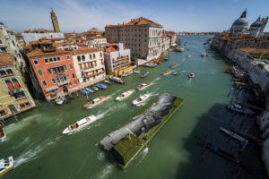 Giant biodegradable landart painting by French-Swiss artist Saype from the Beyond Walls project on Friday April 15, 2022 on a floating barge in Venice, Italy. Extending over an area of 8 by 30 meters this fresco was created using biodegradable pigments made out of charcoal, chalk, water and milk proteins. The piece will travel in and around Venice and will be unveiled during the  Biennale Arte 2022 59th International Art Exhibition.  (Valentin Flauraud for Saype)